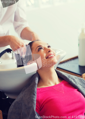 Image of happy young woman at hair salon