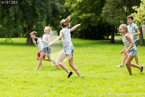 Image of group of happy kids or friends playing outdoors