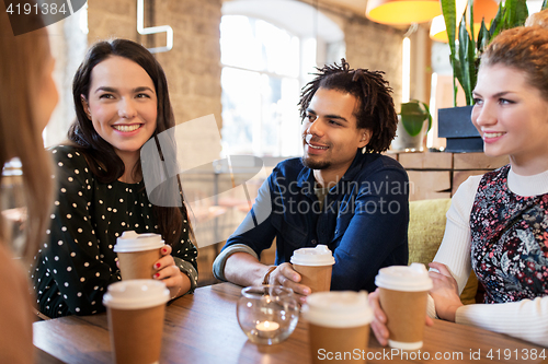 Image of happy friends drinking coffee at restaurant