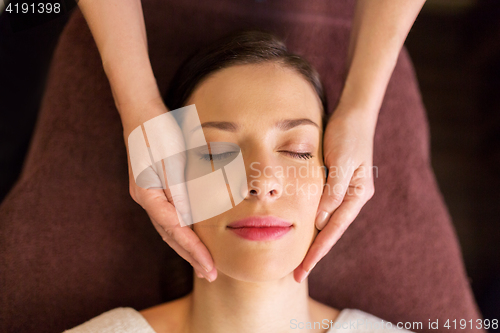 Image of woman having face and head massage at spa