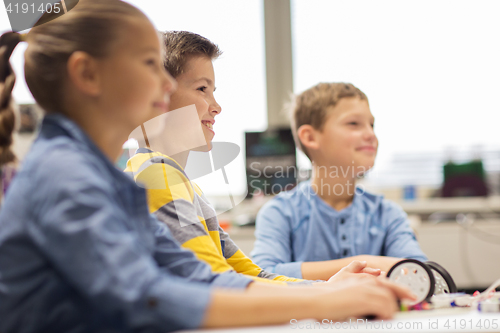 Image of happy children building robots at robotics school