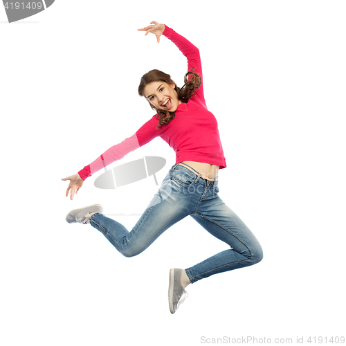 Image of happy young woman jumping in air or dancing