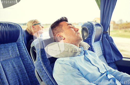 Image of man sleeping in travel bus with cervical pillow