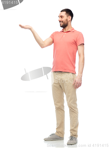 Image of happy man holding something imaginary on hand