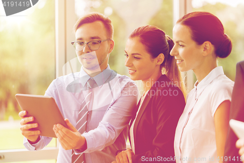 Image of business people with tablet pc computer at office