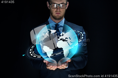 Image of businessman with virtual earth projection