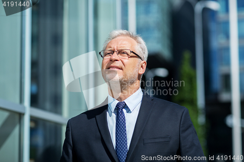 Image of senior businessman on city street