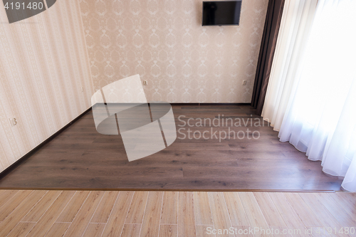 Image of Zoning floor in the interior, ceramic tile smoothly into the living room laminate