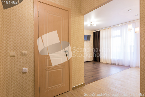 Image of Interior studio, view from the front door to the room and the bathroom door