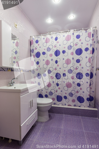 Image of The interior of the bathroom, room with dressing room, shower curtain curtained