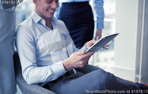 Image of business team working with tablet pc in office