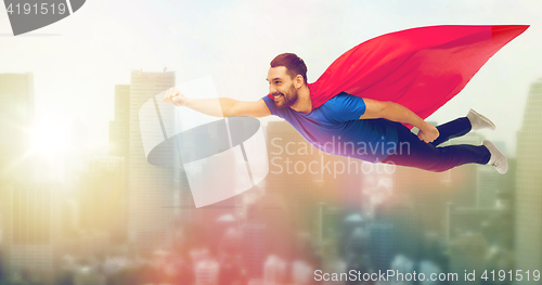 Image of happy man in red superhero cape flying on air