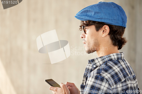 Image of close up of man texting message on smartphone