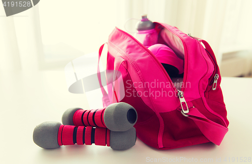 Image of close up of sports stuff in bag and dumbbells