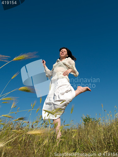 Image of Happy Young Lady Runs Through Field