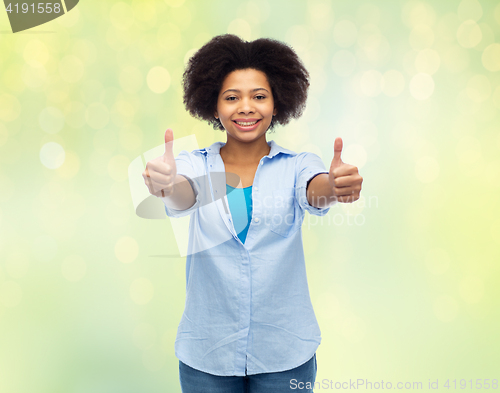 Image of happy african american woman showing thumbs up