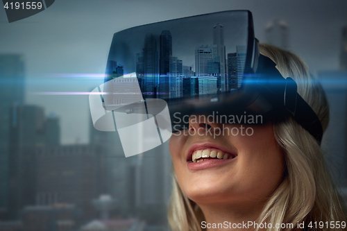 Image of woman in virtual reality headset over city