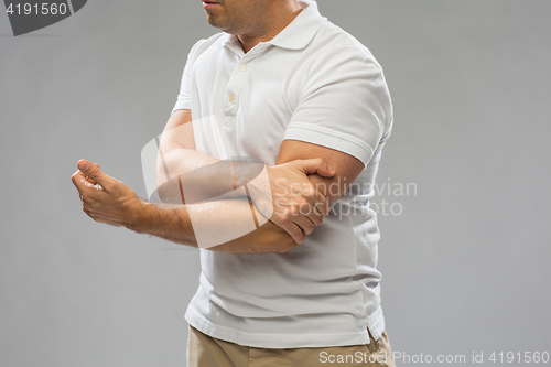 Image of close up of man suffering from pain in hand