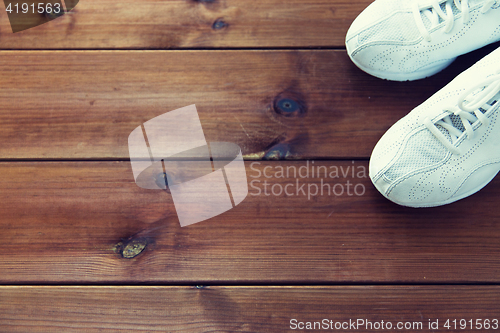 Image of close up of sneakers on wooden floor