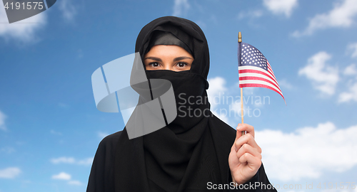 Image of muslim woman in hijab with american flag