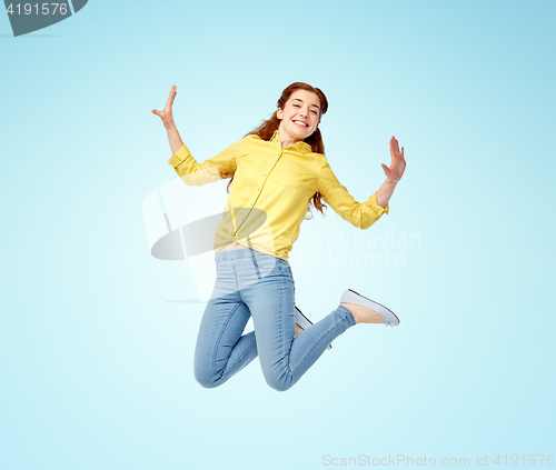 Image of smiling young woman jumping in air