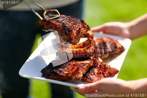 Image of man cooking meat at summer party barbecue