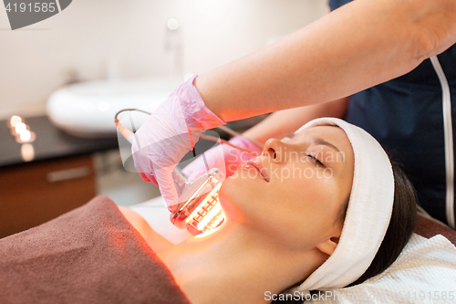 Image of young woman having face microdermabrasion at spa