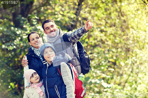 Image of happy family with backpacks hiking