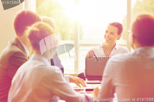 Image of business people with laptop meeting in office