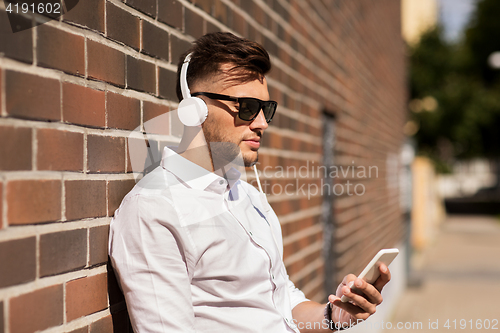 Image of man with headphones and smartphone listening music