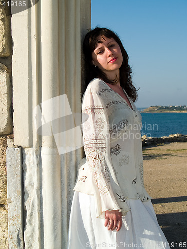 Image of Young lady Leaning Ancient Ruins