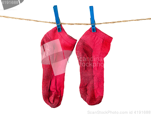 Image of Pair of washed red socks on rope