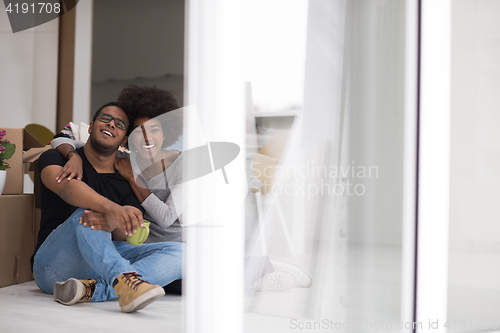 Image of African American couple relaxing in new house