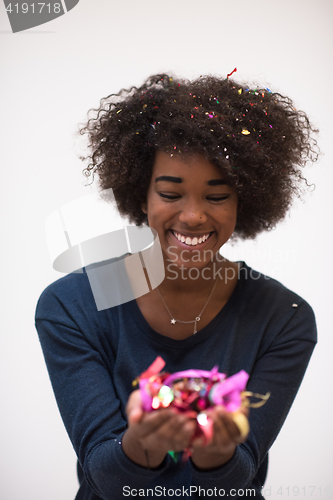 Image of African American woman blowing confetti in the air