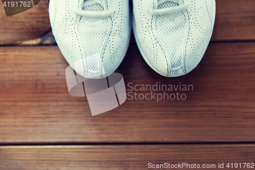 Image of close up of sneakers on wooden floor