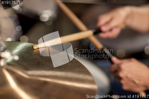 Image of male musician playing drums and cymbals at concert