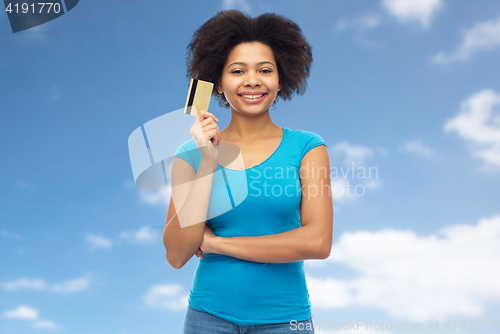 Image of happy afro american woman with credit card