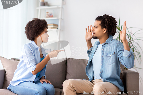 Image of unhappy couple having argument at home