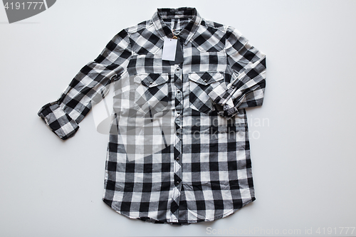 Image of checkered shirt with price tag on white background
