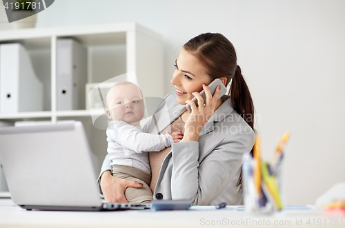 Image of businesswoman with baby and smartphone at office