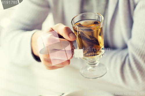 Image of close up of man drinking tea at home or cafe