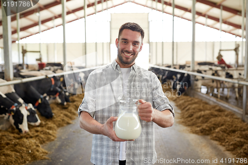 Image of man or farmer with cows milk on dairy farm