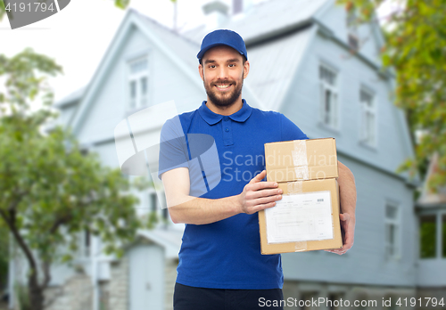 Image of happy delivery man with parcel boxes