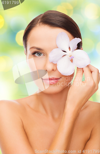 Image of beautiful young woman with orchid flower