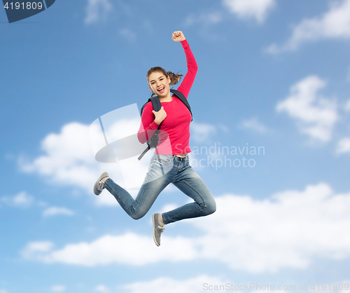 Image of happy woman or student with backpack jumping