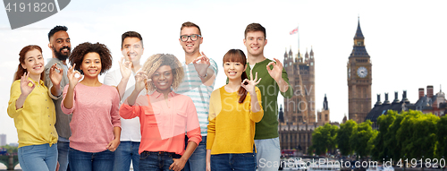 Image of international group of people showing ok in london