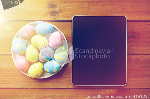 Image of close up of easter eggs and blank tablet pc