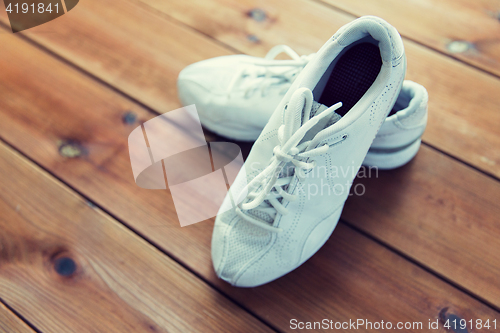 Image of close up of sneakers on wooden floor