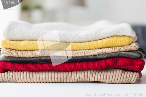 Image of close up of stacked knitted clothes