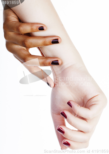 Image of two different nathion manicured hands on white isolated, african